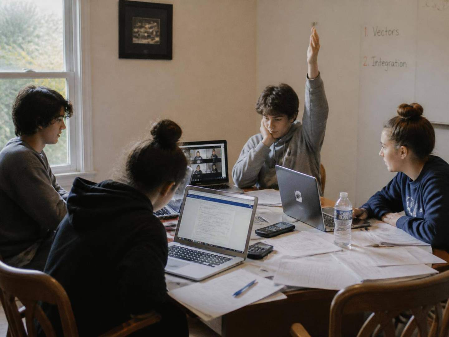 Students working through mathematics together in a small-group session